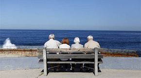 couples facing the beach