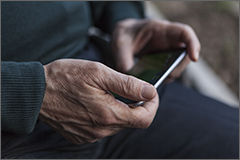 Older man checking his phone