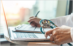 Medical doctor at laptop