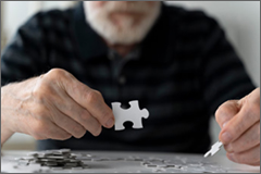 Elderly man building a puzzle