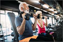 Happy senior people doing exercises in gym to stay fit